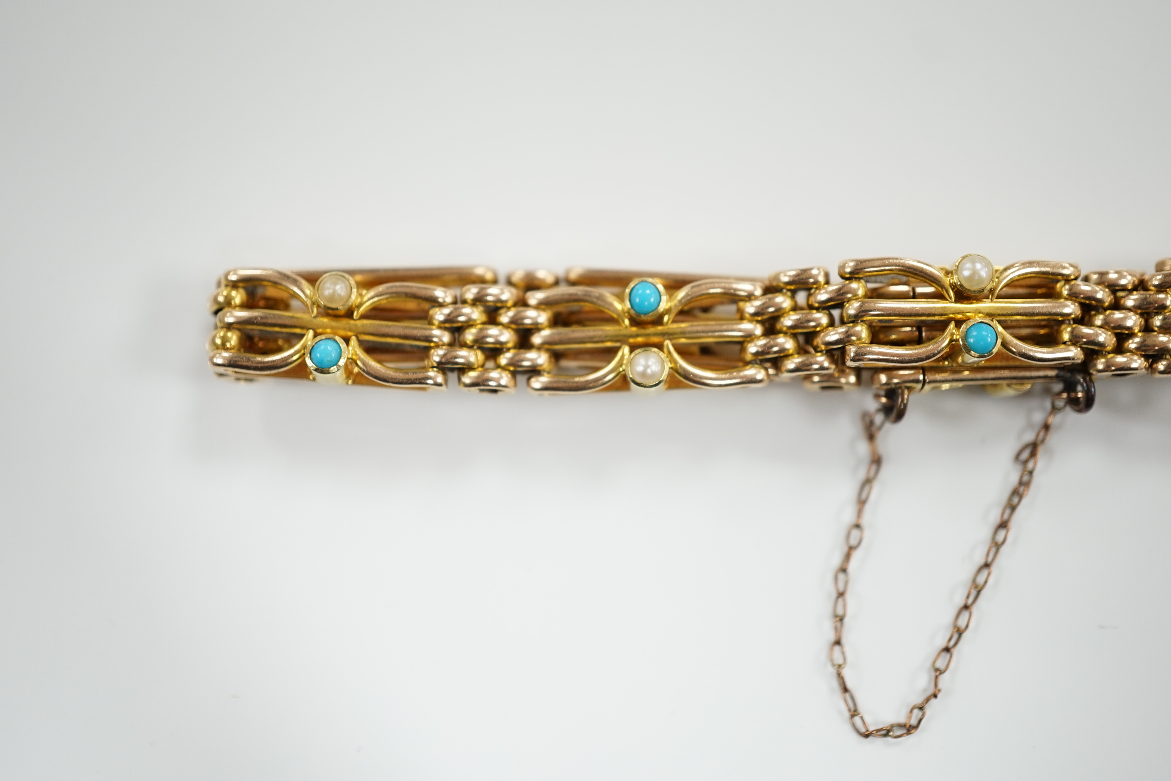 An Edwardian 15ct, turquoise and seed pearl set gate link bracelet, 18cm, gross weight 16.7 grams.